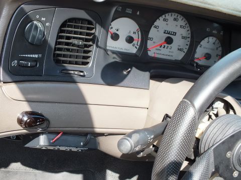 2003 Ford Crown Victoria - Gauge cluster labeled MARAUDER showing speedometer, tachometer and temperature gauges behind the wheel