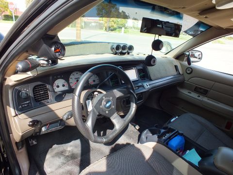 2003 Ford Crown Victoria - Cabin view across to the driver side showing sport wheel, A-pillar gauge and triple dash pod