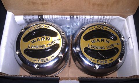 1993 Ford Bronco - Two Warn locking hubs are shown in their original packaging, ready for installation.