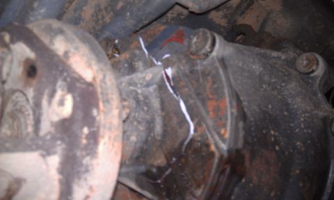 1993 Ford Bronco - A crack in the differential housing is visible, with white sealant applied.