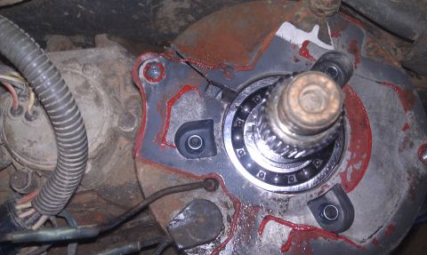 1993 Ford Bronco - Close-up view of a vehicle's transfer case component, showing a bearing and red sealant.