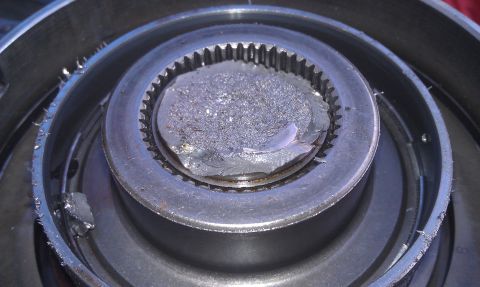 1993 Ford Bronco - Close-up of a damaged mechanical part, showing fractured metal and gear teeth.