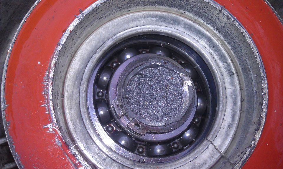 Damaged wheel bearing with broken inner race and debris