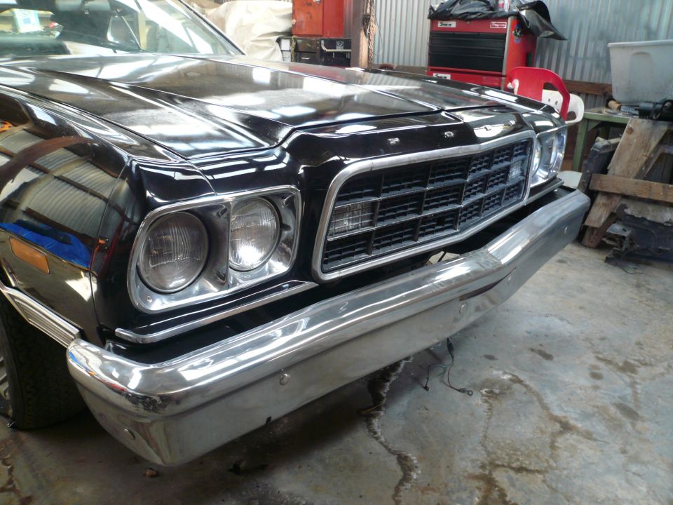 Front view of a black 1977 Ford Ranchero with chrome bumper and grille