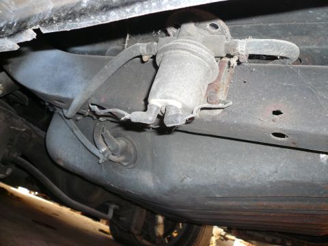 1975 Ford Ranchero - The underside of a vehicle shows a fuel filter connected to the fuel tank.