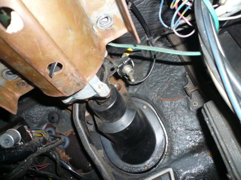 1975 Ford Ranchero - Close-up of the steering column and exposed wiring beneath the dashboard of a vehicle.