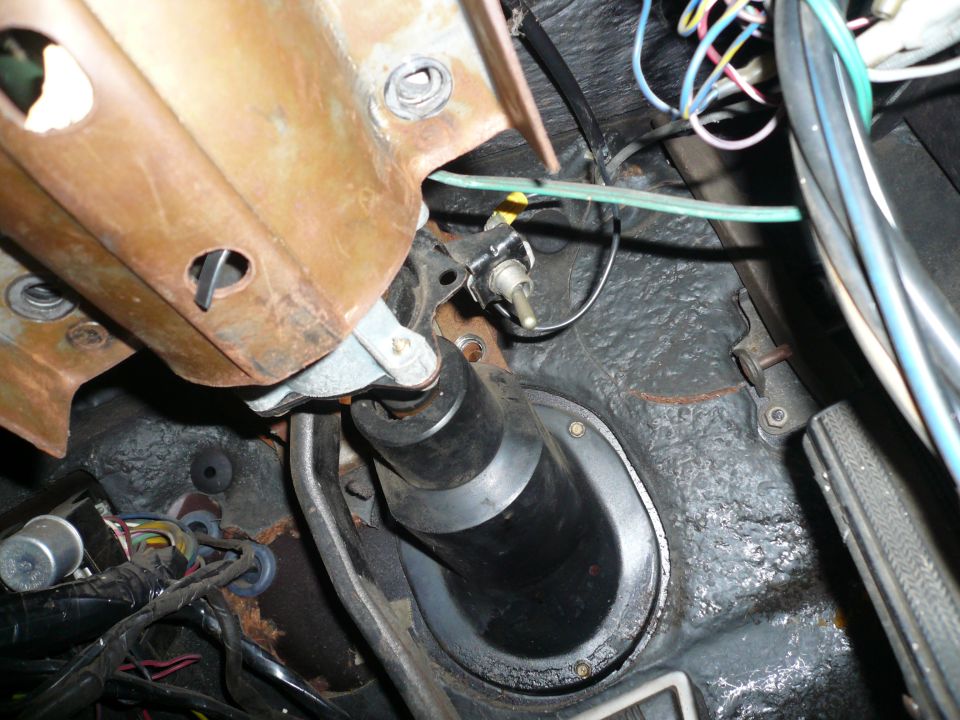 Interior view of steering column and wiring under dashboard