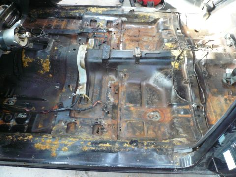 1975 Ford Ranchero - Interior floor pan shows significant rust damage and exposed wiring.