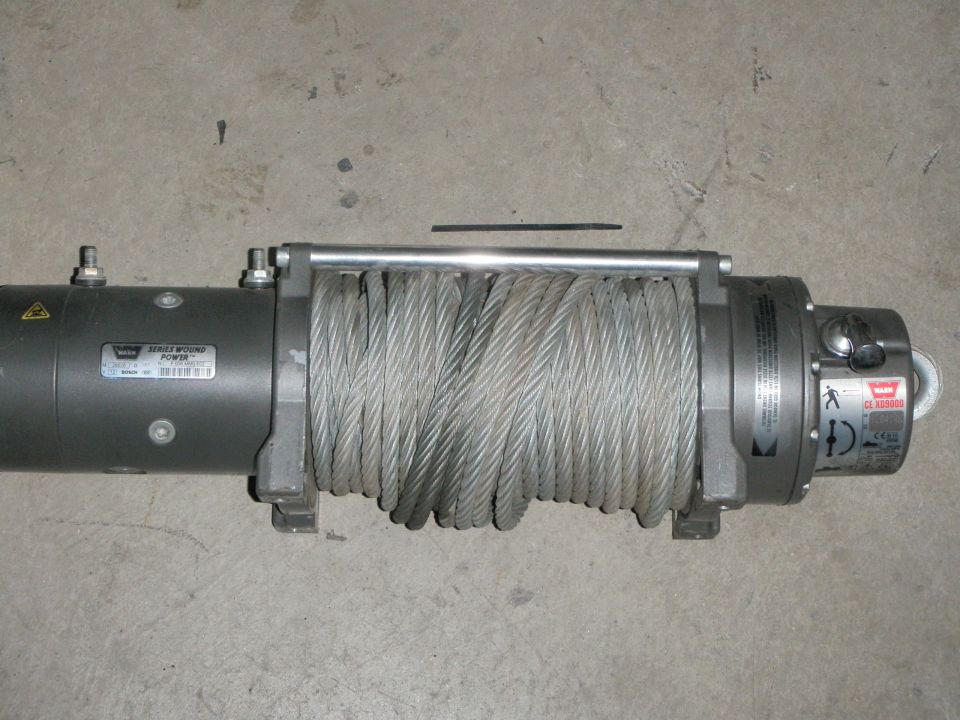 Warn Series Wound Power winch with steel cable on concrete surface