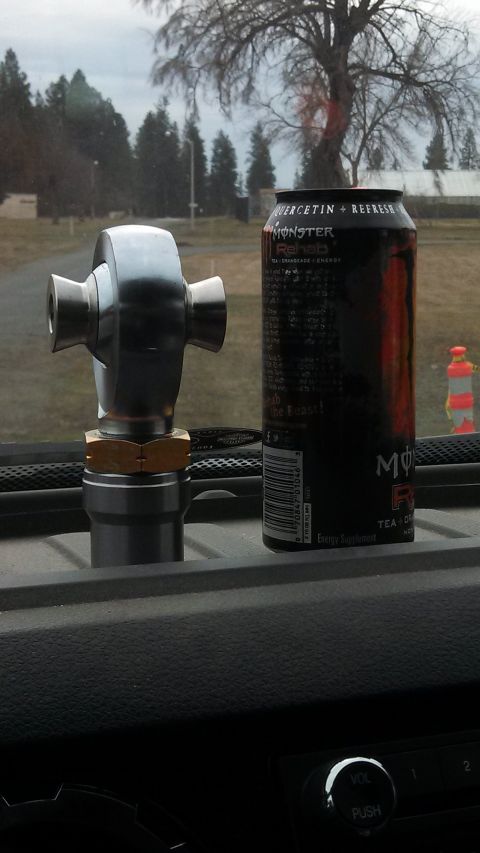 1967 Ford F-250 - A metal automotive part and an energy drink sit on a vehicle's dashboard.