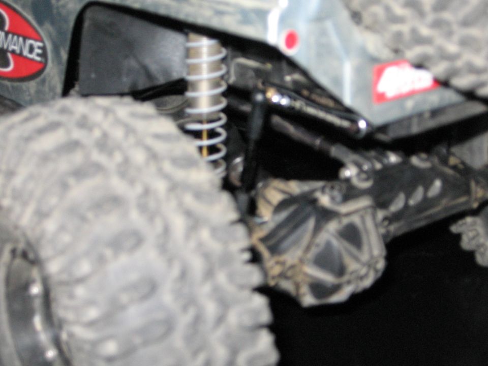 Close-up of off-road suspension and large tire with "Performance" sticker