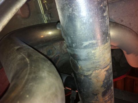 1995 Ford Mustang - Underside view of a vehicle's exhaust system, showing pipes and suspension parts.