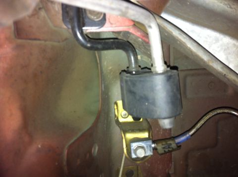 1995 Ford Mustang - Close-up view of an exhaust system hanger assembly, showing rubber and metal components.
