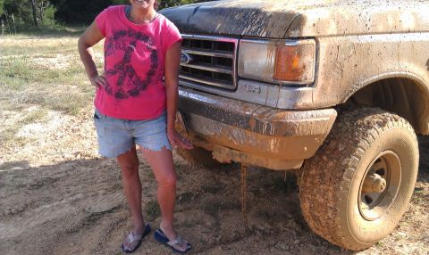 1990 Ford Bronco - This Ford truck, likely from the early 90s, is covered in mud after off-roading.