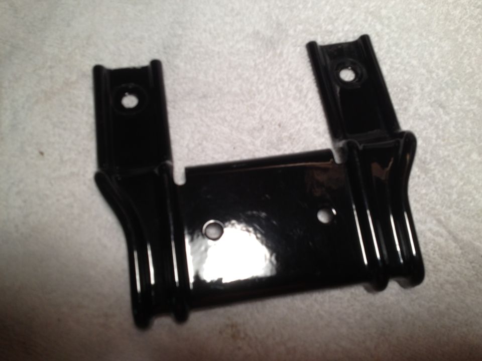 Black metal bracket with two mounting holes on top and one in the center
