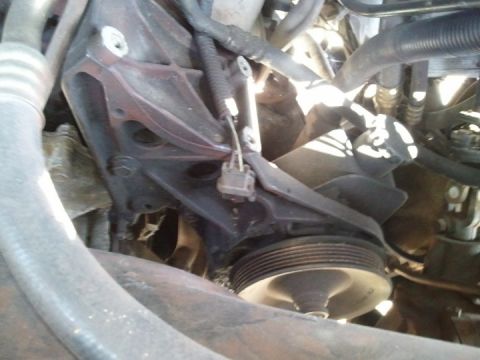 1994 Ford Bronco - Close-up view of an engine pulley and bracket assembly, with visible hoses and wiring.