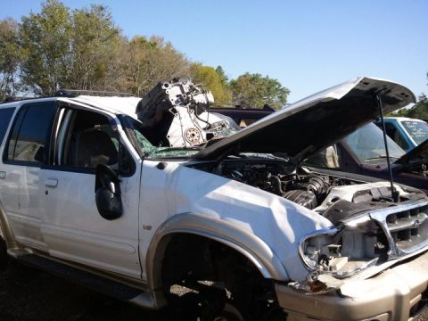 1994 Ford Bronco - This SUV has sustained significant damage, with its engine displaced onto the roof.