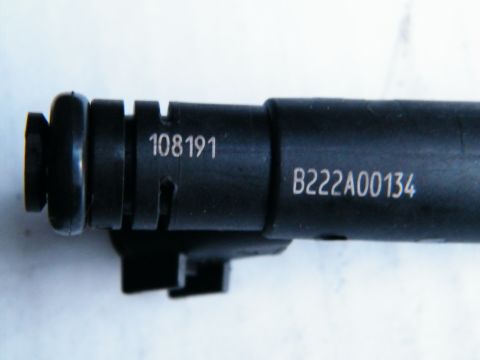 2004 Ford Crown Victoria - A black fuel injector is shown with visible part numbers stamped on its side.