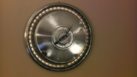 2000 Mercury Grand Marquis - This clock features a Ford hubcap as its face, with the brand's name clearly visible in the center.