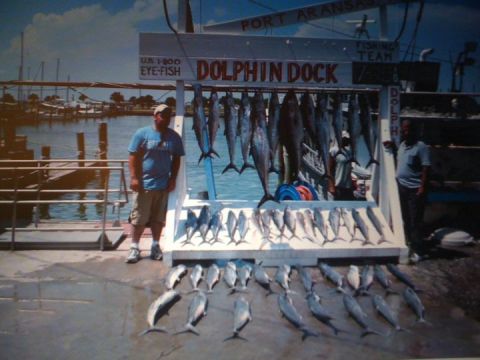 1989 Ford Bronco - A busy fishing dock displays a large catch of various fish, with two men standing nearby.