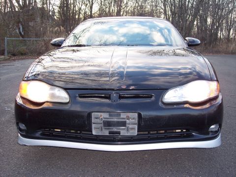 2002 Chevrolet Monte Carlo - The front of a black Chevrolet Monte Carlo is shown with the headlights illuminated.
