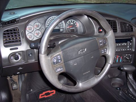 2002 Chevrolet Monte Carlo - The dashboard of a Chevrolet Monte Carlo features a steering wheel with controls and a full set of gauges.