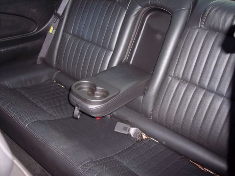 2002 Chevrolet Monte Carlo - The rear interior of a 2002 Chevrolet Monte Carlo features perforated leather seats and a center console with dual cup holders.