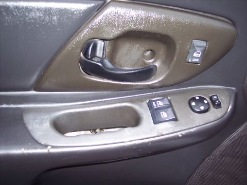 2002 Chevrolet Monte Carlo - Close-up of a car's interior door panel, showing the window controls and door handle.