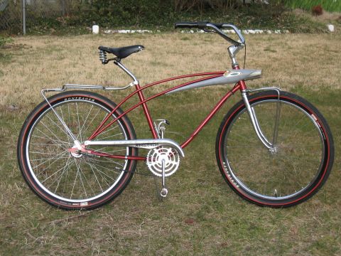 1994 Ford Bronco - A red cruiser bicycle with chrome accents is parked on a grassy lawn.