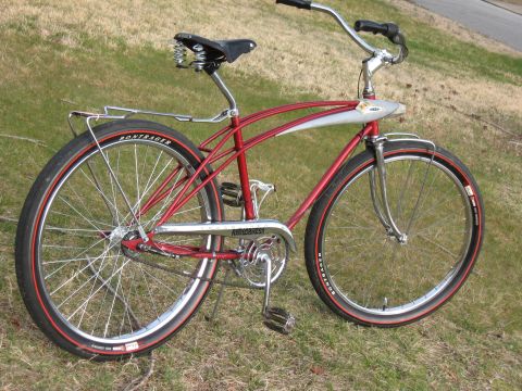 1994 Ford Bronco - A red cruiser bicycle with chrome fenders and a spring saddle sits on grass.
