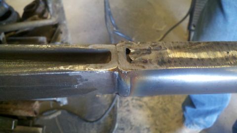 1996 Ford Bronco - Close-up view of a metal frame section that has been welded, showing a gap between the two pieces.