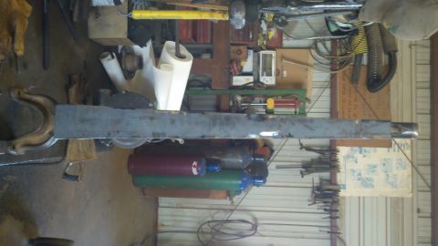 1996 Ford Bronco - Workshop scene with metal fabrication in progress, including welding supplies and tools.