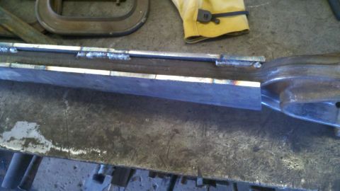 1996 Ford Bronco - Metal fabrication work in progress on a workbench.