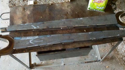 1996 Ford Bronco - Metal parts are being worked on at a workbench, with a bag of dill pickle chips visible in the background.