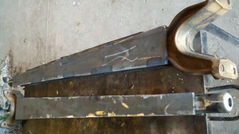 1996 Ford Bronco - Custom suspension parts are shown laid out on a work surface.