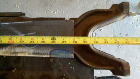 1996 Ford Bronco - A yellow measuring tape is placed on a metal component, indicating a length measurement.