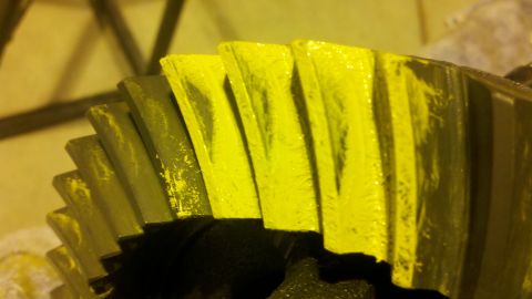 1996 Ford Bronco - Close-up of a differential gear with yellow paint and signs of wear.