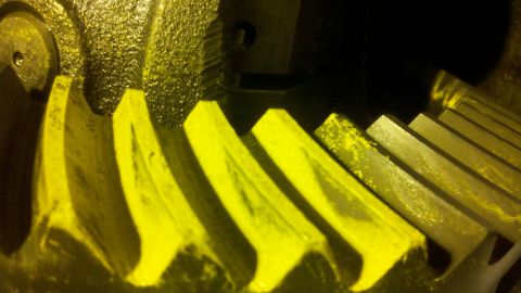1996 Ford Bronco - Differential gears are shown in a close-up view, with yellow coating and signs of wear.