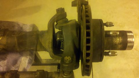 1996 Ford Bronco - Close-up view of a vehicle's front axle assembly, including the brake rotor and hub.