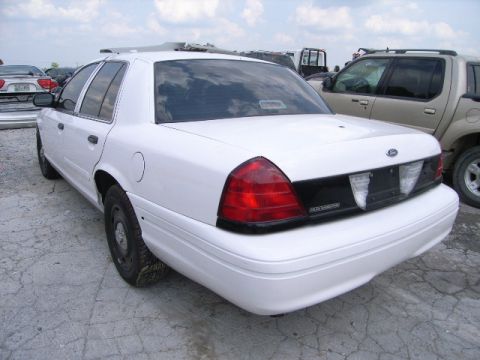 2003 Ford Crown Victoria - Rear view of a white 2003 Ford Crown Victoria sedan in an outdoor lot.