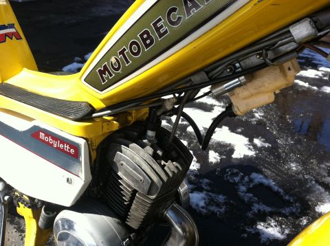 1981 Garelli Rally Sport - Close-up view of a yellow Motobecane Mobylette moped's engine and frame, with visible text branding.