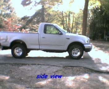 2000 Ford F-150 - Side view of a silver 2000 Ford F-150 pickup truck parked outdoors.