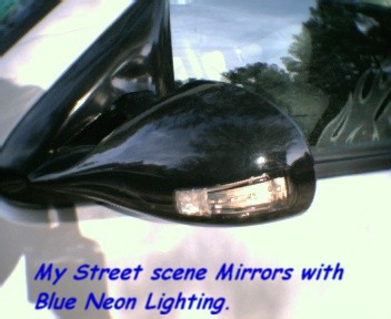 2000 Ford F-150 - Side mirror with integrated turn signal and blue neon lighting, as seen in a street scene.