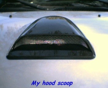 2000 Ford F-150 - Aftermarket hood scoop installed on the hood of a vehicle.