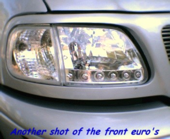 2000 Ford F-150 - Close-up of the driver's side headlight on a silver 2000 Ford F-150.