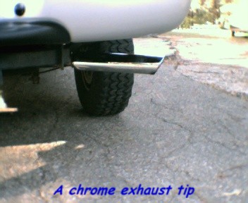 2000 Ford F-150 - A close-up shot of a truck's exhaust pipe and tire, with SuperMotors branding visible.