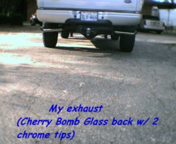 2000 Ford F-150 - Rear view of a silver Ford F-150 pickup truck, showing its dual exhaust system and trailer hitch.