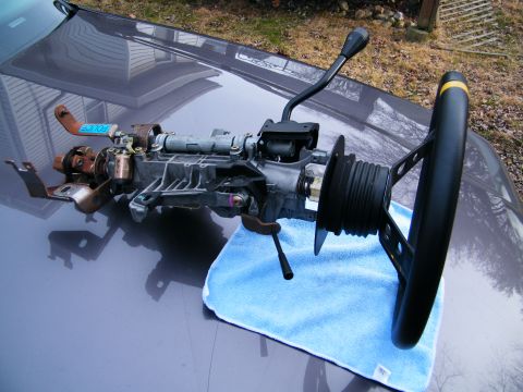 2004 Ford Crown Victoria - Steering column assembly with shifter lever and aftermarket steering wheel, with a 'POLICE' tag attached.