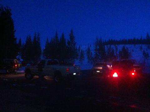 1989 Ford Bronco - Pickup trucks parked in a snowy landscape during twilight.