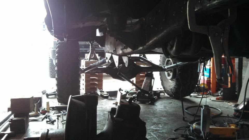 Undercarriage of a lifted truck with suspension components visible